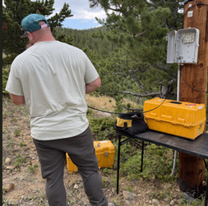 Trace fiber technician repairing damaged OSP fiber at Colorado gold mine